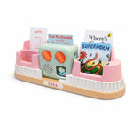 May include: A pink and green children's toy with a wooden base. The toy has slots for cards and a central speaker unit. The cards feature illustrations and text, including "Old MacDonald" and "Superworm". The toy is labeled "LIYA".